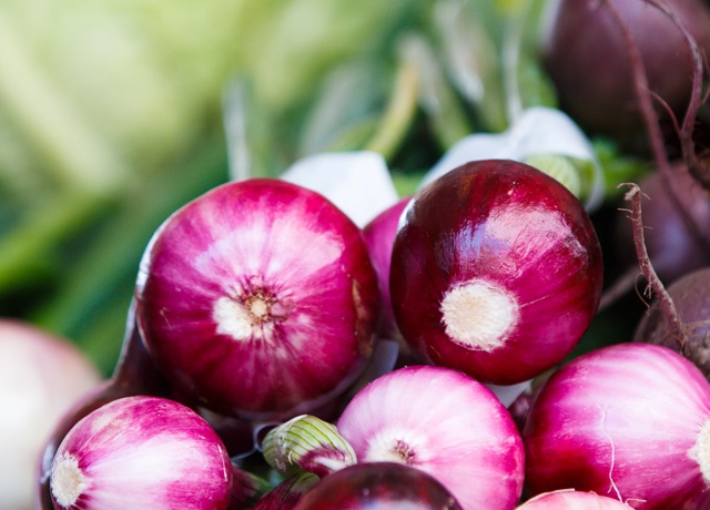 Bottom view of a stack of freshly cut red onions